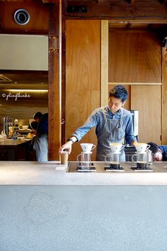 a man standing behind a counter preparing food