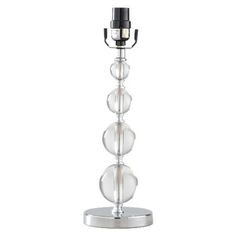 a glass candle holder with three clear balls on the base and a silver metal stand