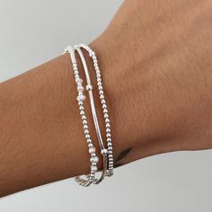 Elevate your look with this beautiful Freshwater Pearl & Sterling Silver Stretch Bracelet! Made with genuine freshwater pearls and 925 sterling silver beads, it will add a touch of elegance to any outfit. The stretch design makes it easy to slip on and off, and it fits comfortably on most wrist sizes.  Experience the timeless beauty of pearls and sterling silver or gift it to someone you love. Perfect on its own or layer with other pieces from our collection.  The other bracelets pictured are not included, but are available on our website and in our Etsy store 💖 Details 925 Sterling Silver Pearls: 3-4 mm Heart: 11 nmm Diameter: approx 18 cm  Fits S/M wrists 💖 Online store: www.thejewellerytree.net 💕 Stay up-to-date with new designs & special offers  - FOLLOW ME   Socials: @myjewellerytr Silver Stackable Pearl Bracelet Gift, Silver Stackable Pearl Bracelet With Round Beads, Silver Bracelet Stack, Bracelet Pearl, Sterling Bracelets, Ball Bracelet, Freshwater Pearl Bracelet, Jewelry Tree, Christmas 2024