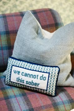 a pillow sitting on top of a couch next to a pillow that says, we cannot do this sobber