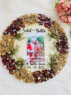 a personalized christmas ornament on a table with flowers