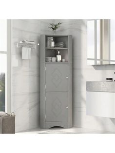 a bathroom with a white sink and gray cabinet