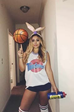 a woman in bunny ears holding a basketball