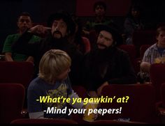 a group of people sitting in a movie theater with the caption what're ya gawkin at? - mind your peepers