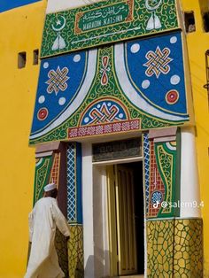 a man walking into a brightly colored building