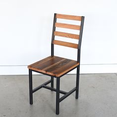 a wooden chair sitting on top of a cement floor