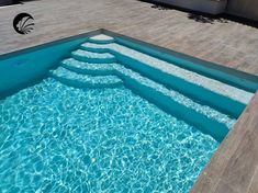 an empty swimming pool with clear blue water