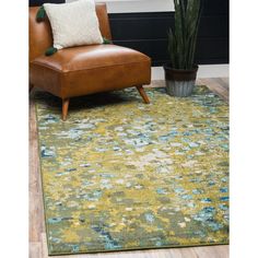 a brown chair sitting in front of a green rug