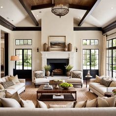 a living room with couches, chairs and a fire place in the middle of it