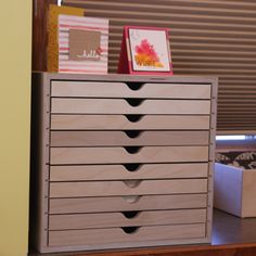 a dresser with many drawers and pictures on it