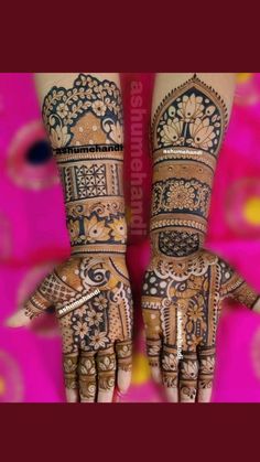 two hands with henna designs on them