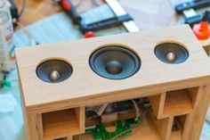 two wooden speakers sitting on top of a table