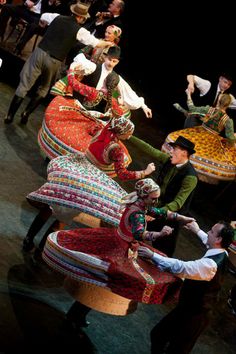 a group of people standing around each other on stage