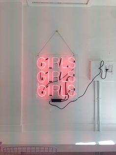 a neon sign hanging from the side of a wall