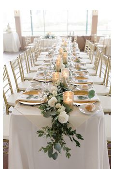 a long table is set with candles and plates