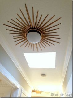 a sunburst hanging from the ceiling above a hallway