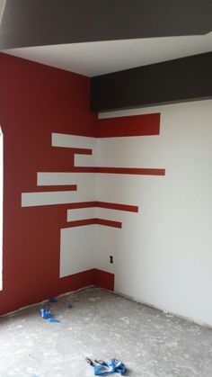 an empty room with red and white walls