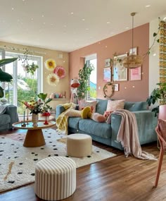 a living room filled with lots of furniture and decor on top of a hard wood floor