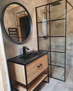 a bathroom with a sink, mirror and stand up shower stall in it's corner