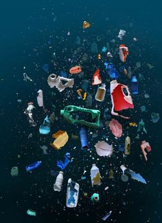 many different colored plastic bottles floating in the water