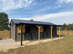 a horse barn with two stalls in the middle