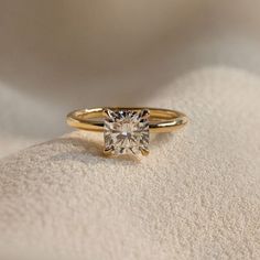 a yellow gold ring with a single diamond