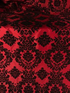 a red and black table cloth with an intricate design