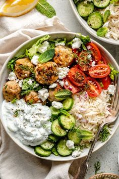 two bowls filled with different types of food and garnished with cucumbers