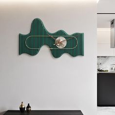 a kitchen with white walls and black countertops has a green fish clock on the wall