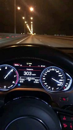 the dashboard of a car at night with lights on and speedometers lit up