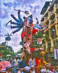 a group of people standing around an elephant float