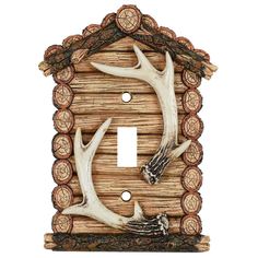 deer antlers are mounted to the wall in this rustic light switch plate cover holder