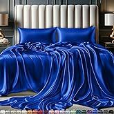 a bed covered in blue sheets and pillows