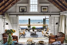 a living room filled with furniture and a view of the ocean