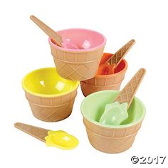 four ice cream cones with scoops and spoons in each one, on a white background