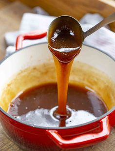 the sauce is being poured into the pot