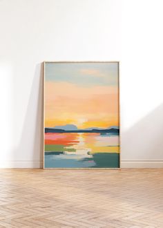 a painting is hanging on the wall in an empty room with hard wood flooring