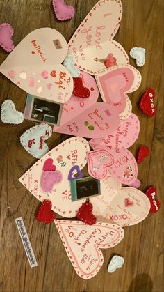 valentine's day tags are laid out on the floor next to some other hearts