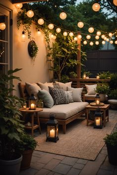 an outdoor seating area with lanterns and lights