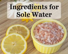 ingredients for sole water on a wooden table with lemons and daisies in the background