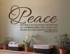 a wall decal that says peace with flowers and baskets on the mantle in front of it