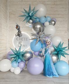 the frozen princess is standing in front of balloons and star shaped decorations for her birthday party