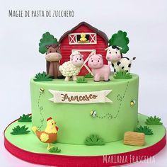 a green cake with farm animals on it