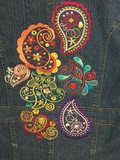 the back of a jean jacket with colorful embroidered paisley designs on it's side