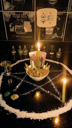 a bowl filled with candles sitting on top of a table