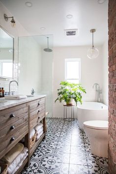 a bathroom with black and white tiles on the floor