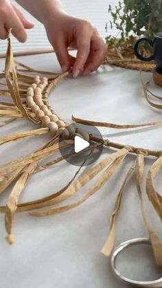 someone is making something out of wood and rope