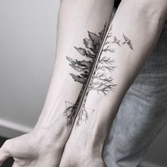 two people with matching tattoos on their arms