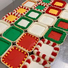 a table topped with lots of decorated cookies