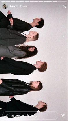 three young men standing next to each other in front of a white wall with the word love written on it